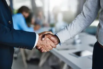 Shaking hands once in agreement.