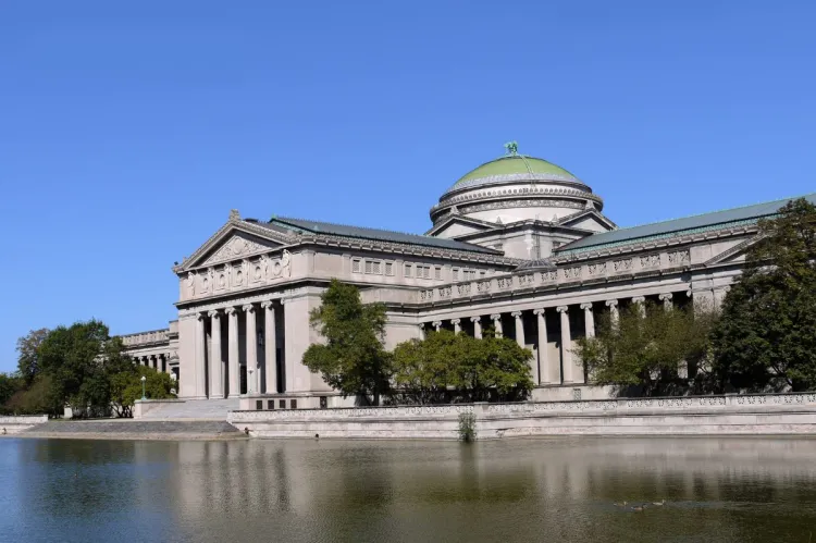 Museum of Science and Industry in Chicago with neoclassical architecture, green dome, and reflecting pond.