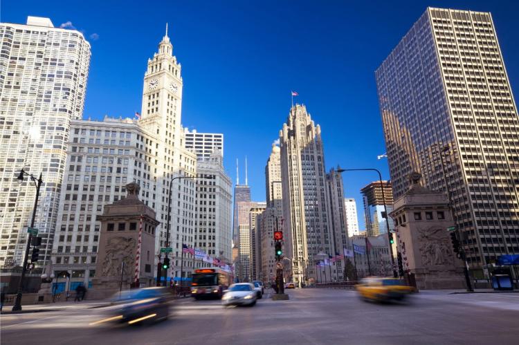 Chicago's Magnificent Mile with iconic buildings, including the Wrigley Building and Tribune Tower, under a clear blue sky