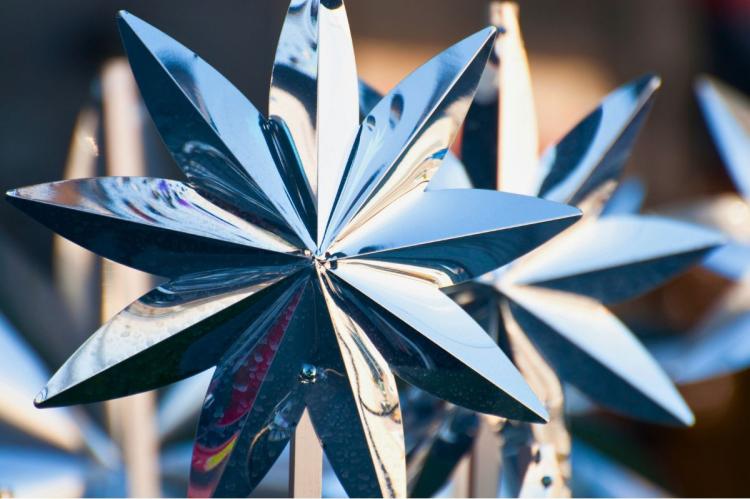 Close-up of reflective star-shaped chrome decorations.