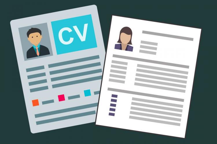 Two resumés on a table.